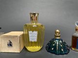 three bottles of perfume sitting next to each other on a table