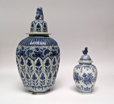 two blue and white vases sitting next to each other