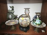 many vases and plates on a shelf in a room