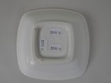 a white plate with a square design on it