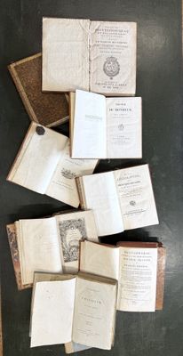 many open books on a table with a black background