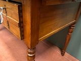a wooden table with a drawer on top of it