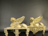 pair of carved ivory figurines of angels resting on a table