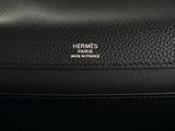 a close up of a black leather bag with a logo on it
