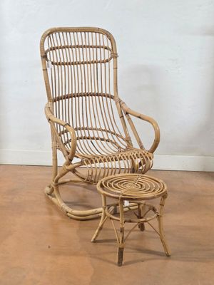 a wicker rocking chair and a small table on the floor