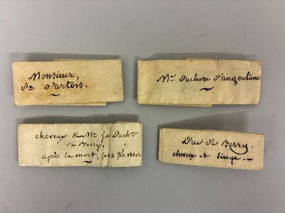 three pieces of paper with handwriting on them sitting on a table