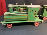 a green toy train sitting on top of a black table