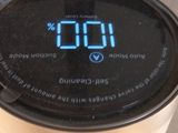 a digital clock on the side of a coffee maker
