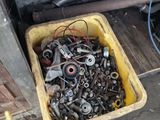 a yellow container filled with assorted metal parts