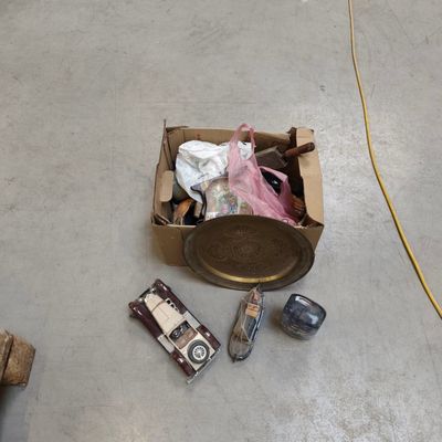 a box of assorted items sitting on the floor