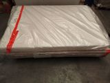 a mattress that is wrapped in plastic and sitting on the floor