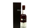 the bottle of whisky is next to the box on the table