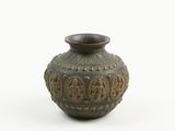 a small vase that is sitting on a white surface