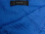 a close up of a blue scarf with a black label on it