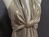 a mannequin with a gold dress on a mannequin mannequin