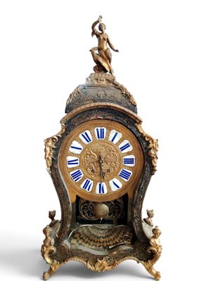 a clock with a statue on top of it on a white background