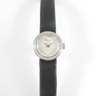 a close up of a watch on a black leather strap