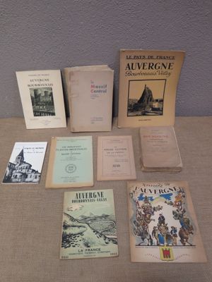 several books are sitting on a table in front of a wall