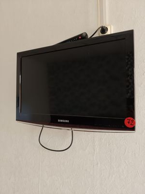 a flat screen tv hanging on the wall in the room