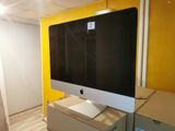 a computer monitor sitting on top of a desk in a room