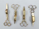 five different types of scissors and a knife on a table