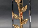 a lamp that is sitting on a table with a flower on it