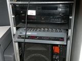 a stack of audio equipment in the corner of a room