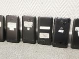 several cell phones lined up in a row on the floor