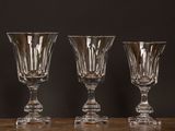 three empty wine glasses sitting on top of a wooden table