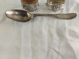 two spoons and a spoon on a white cloth
