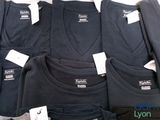 a lot of t - shirts that are sitting on a table
