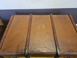 three suitcases stacked on top of each other on a table