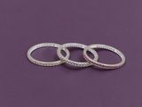 three silver rings with words on them on a purple background