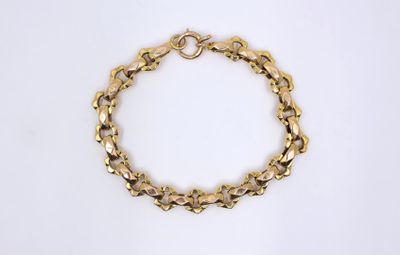 a close up of a gold bracelet on a white background
