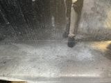 a black and white photo of a person walking in the rain