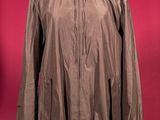 jacket on a mannequin stand against a red background