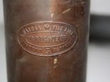 a close up of a metal bottle with a label on it