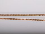 a close up of a gold chain on a white background