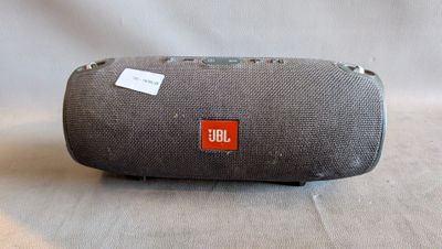 the jbl charger is sitting on a table with a tag on it
