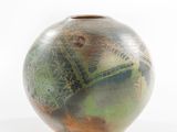a vase with a green and brown design on it