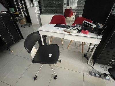 a desk with a computer on it and a chair in front of it