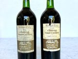 two bottles of wine sitting on a marble table