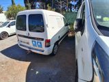 a white van parked next to a white van in a parking lot
