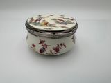 a close up of a small white box with flowers on it