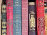 many old books in a box on the shelf