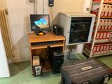 a computer desk with a monitor and other electronics