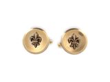 two gold cufflinks with fleur de lis on them