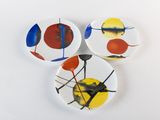 three plates with different designs on them on a white surface