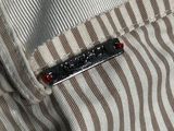 a button on a shirt that is sitting on a table