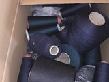 many spools of thread in a cardboard box